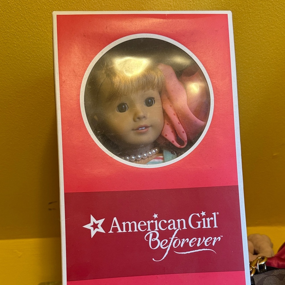 American Girl Doll with Blonde Hair and Pink Accessory